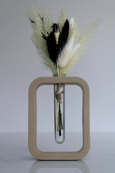 A charming beige mini vase, meticulously crafted by hand. The vase stands at a petite height, showcasing the artistry and attention to detail put into its creation. Its smooth surface boasts a warm beige finish, exuding a sense of elegance and tranquility. The compact size of the vase makes it perfect for showcasing a single delicate flower or a small floral arrangement. The organic curves and gentle contours of the vase add a touch of grace to any space, making it an exquisite addition to your home decor.