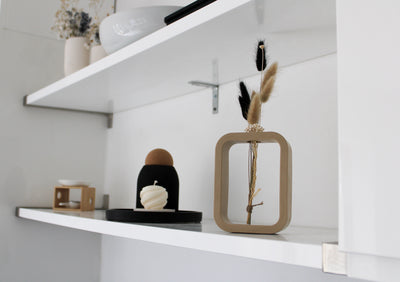 A charming beige mini vase, meticulously crafted by hand. The vase stands at a petite height, showcasing the artistry and attention to detail put into its creation. Its smooth surface boasts a warm beige finish, exuding a sense of elegance and tranquility. The compact size of the vase makes it perfect for showcasing a single delicate flower or a small floral arrangement. The organic curves and gentle contours of the vase add a touch of grace to any space, making it an exquisite addition to your home decor.