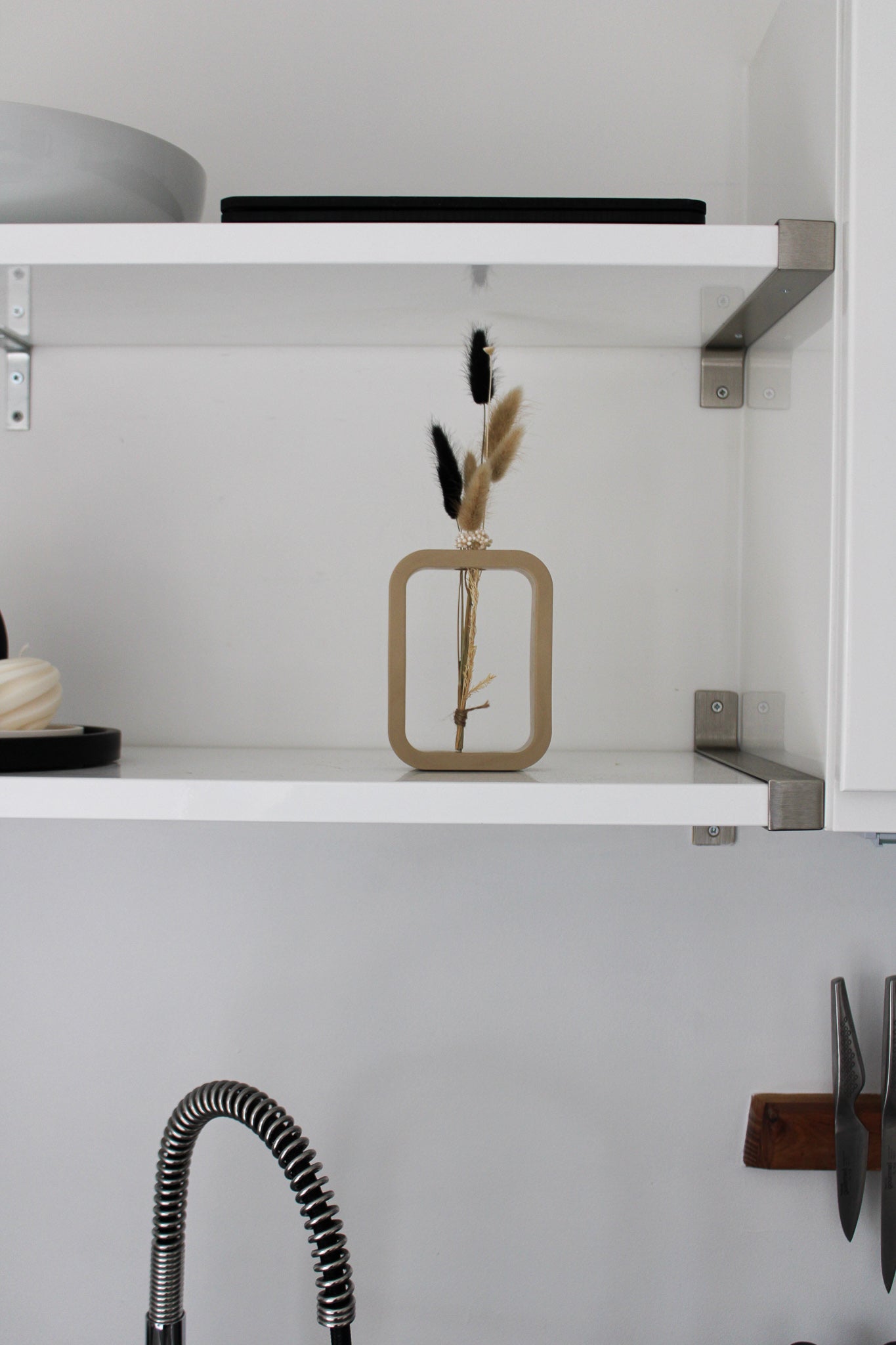 A charming beige mini vase, meticulously crafted by hand. The vase stands at a petite height, showcasing the artistry and attention to detail put into its creation. Its smooth surface boasts a warm beige finish, exuding a sense of elegance and tranquility. The compact size of the vase makes it perfect for showcasing a single delicate flower or a small floral arrangement. The organic curves and gentle contours of the vase add a touch of grace to any space, making it an exquisite addition to your home decor.