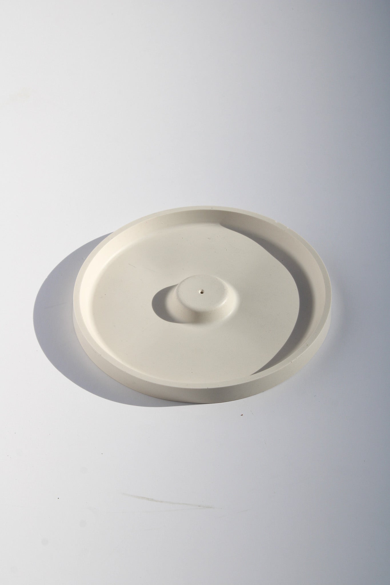 Minimalist incense holder with smooth round shape—perfect decorative accent for serene, modern home decor.