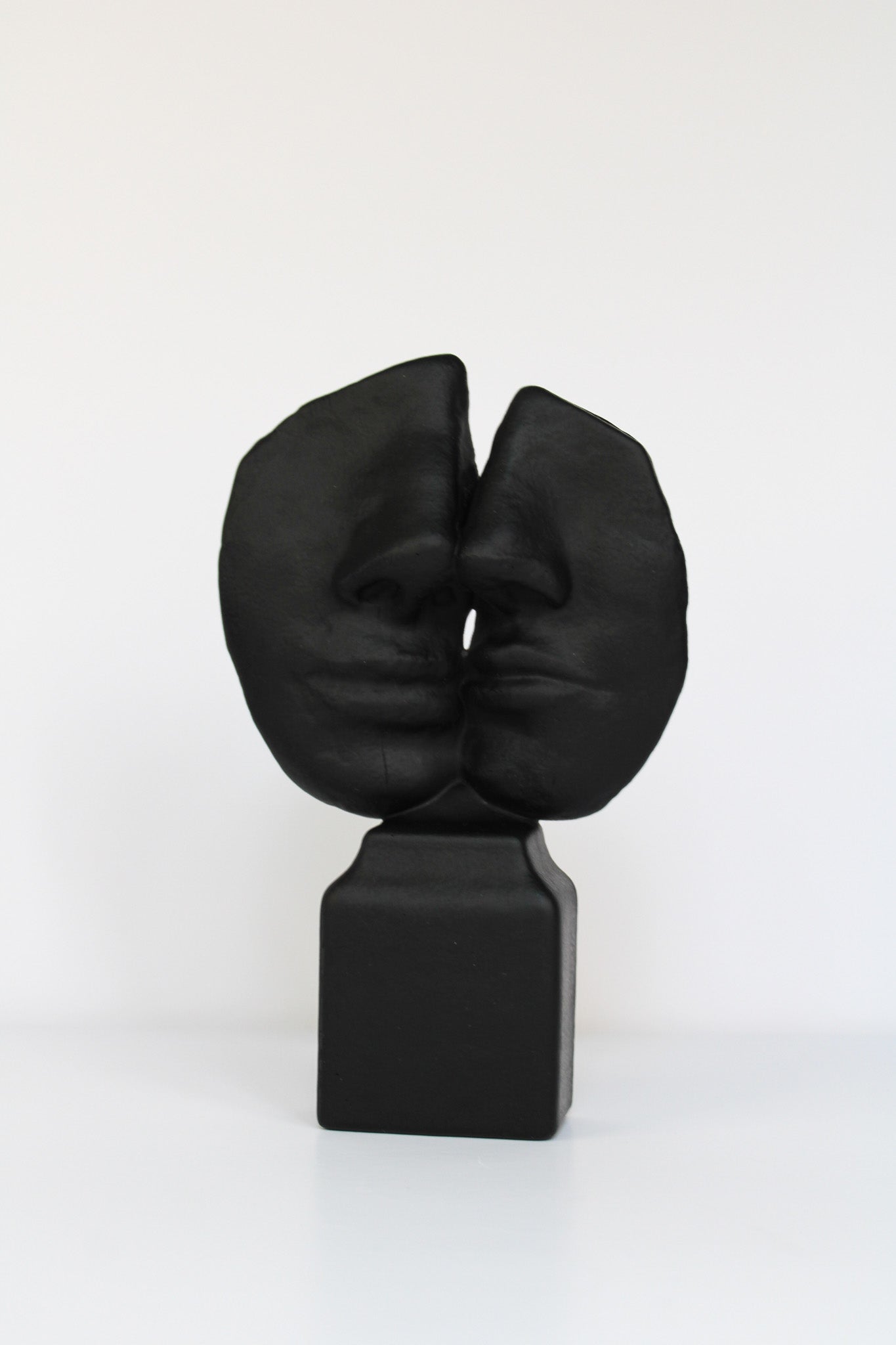 Black abstract sculpture on a white background
