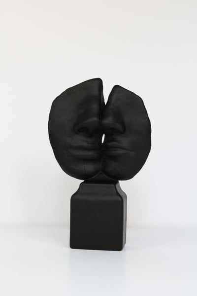 Black abstract sculpture on a white background